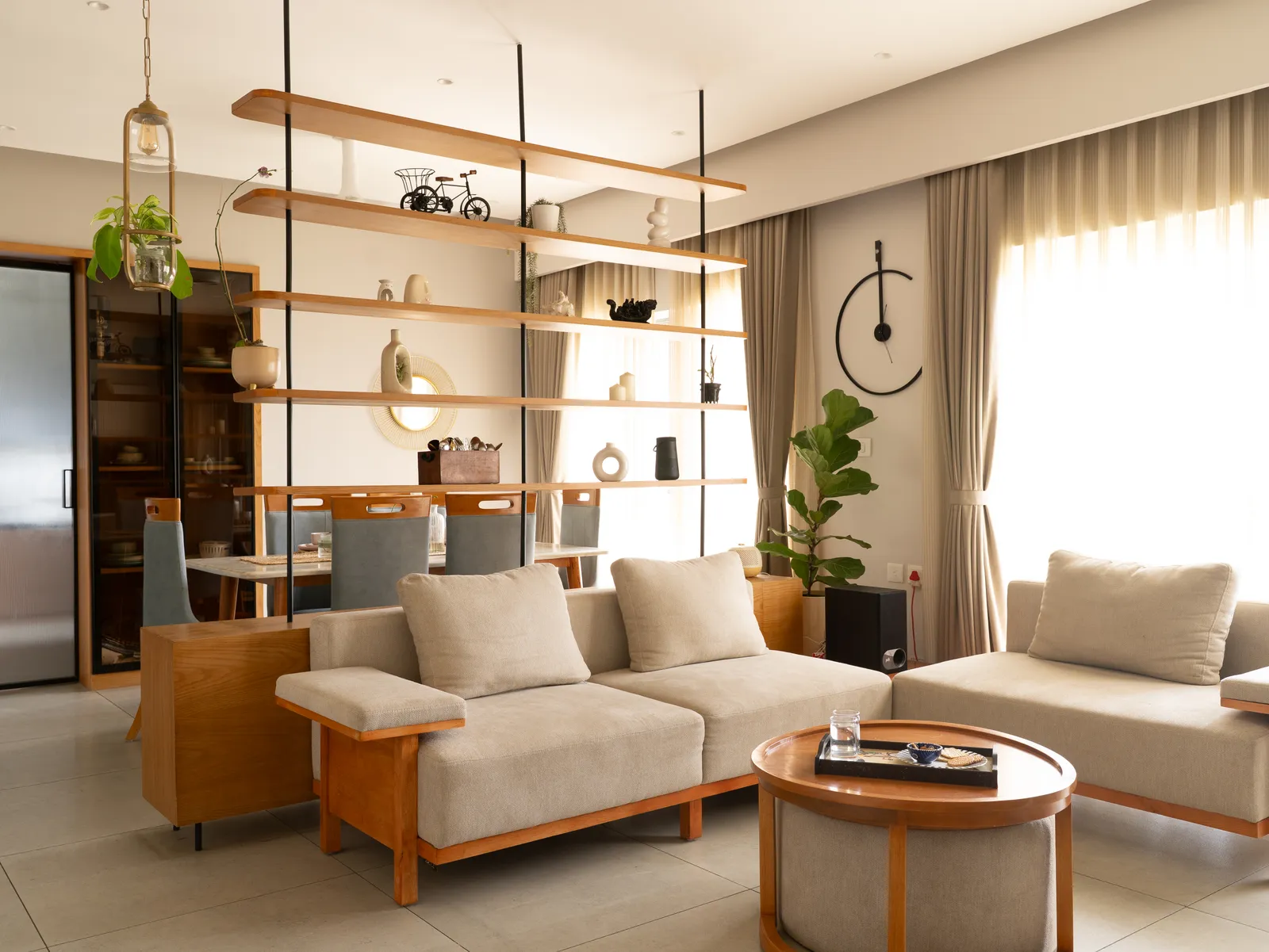 Oak-frame sofa set with round coffee table and open shelving — Amlan's Residence